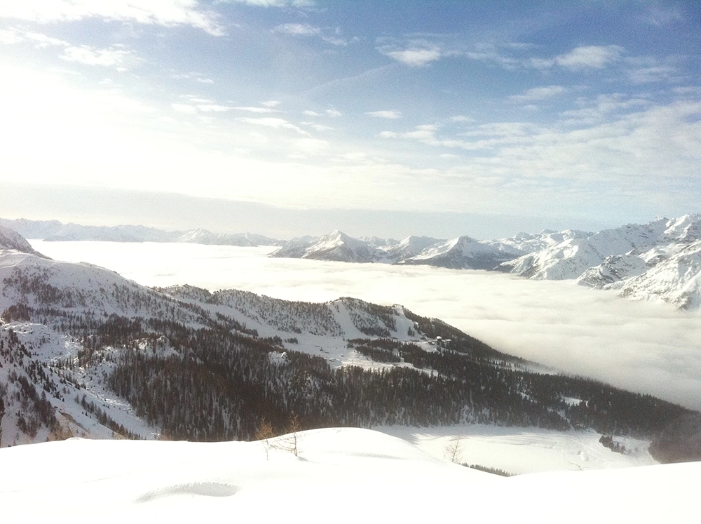 view of the snowy alps above the clouds